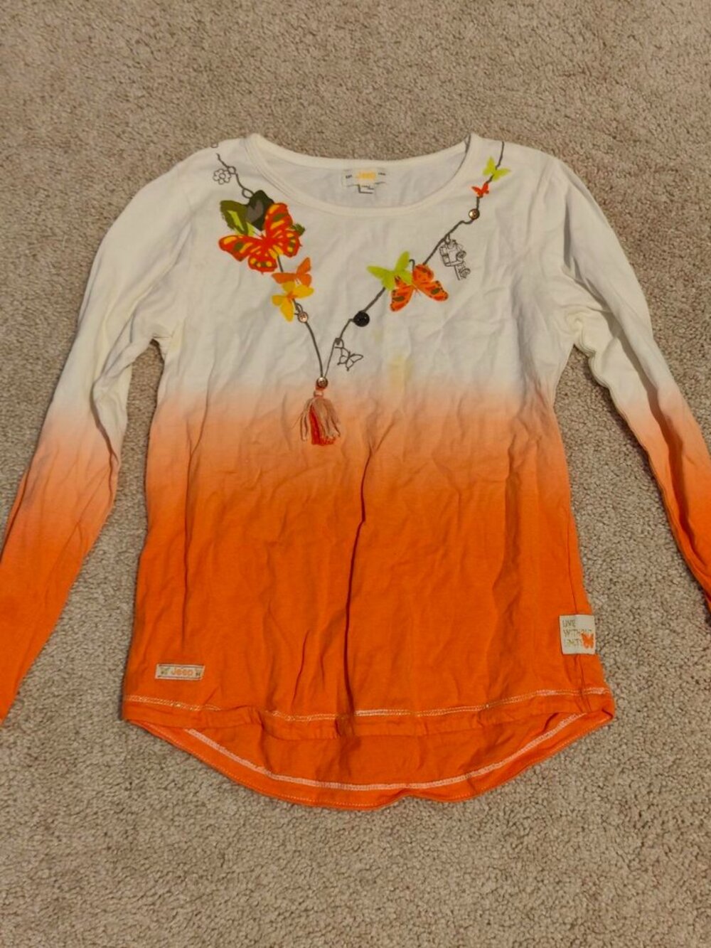 Orange and white long sleeve top with butterfly design
